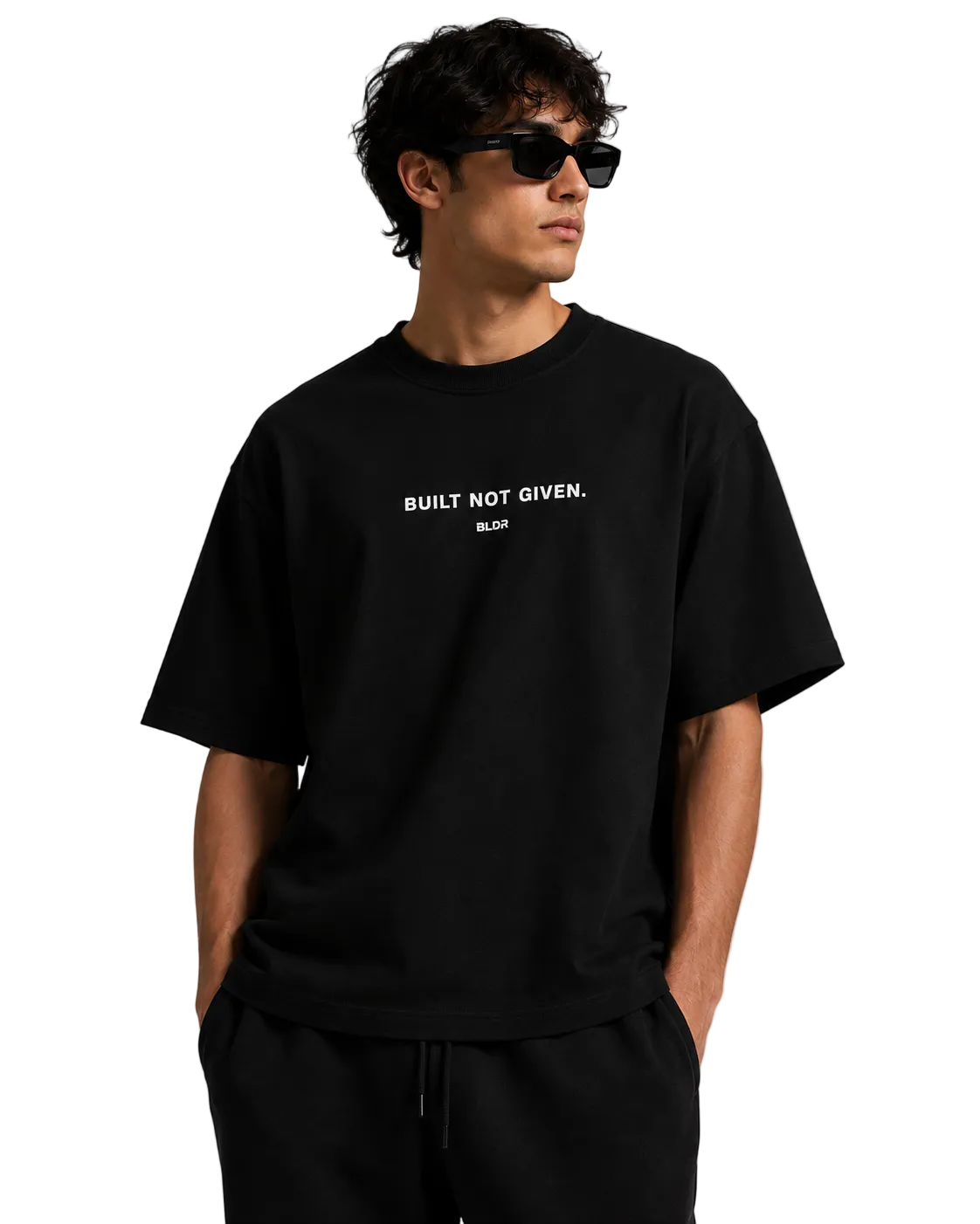 Man wearing a black t-shirt with 'BUILT NOT GIVEN' text on a plain background