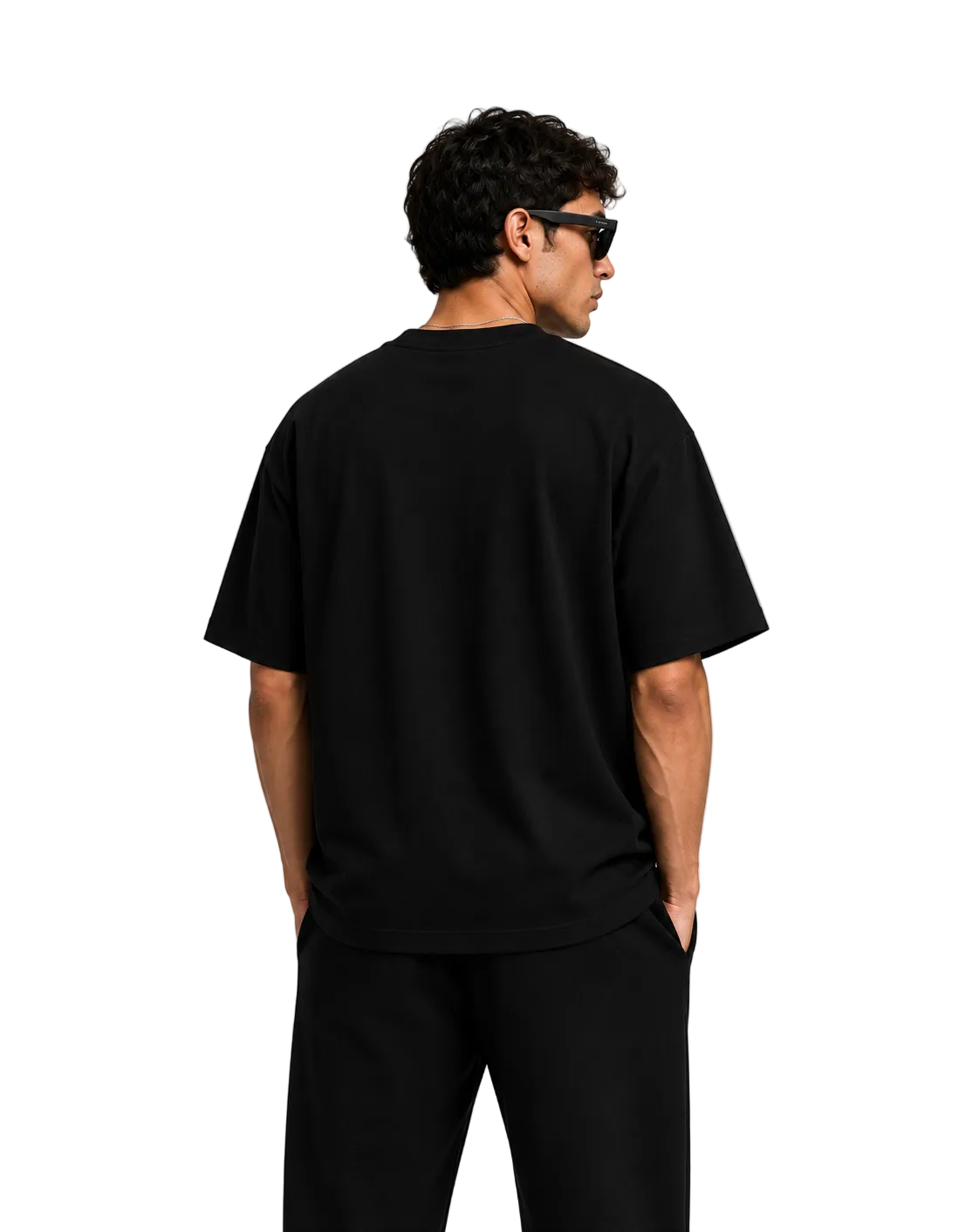 Person wearing a black t-shirt and pants on a plain background