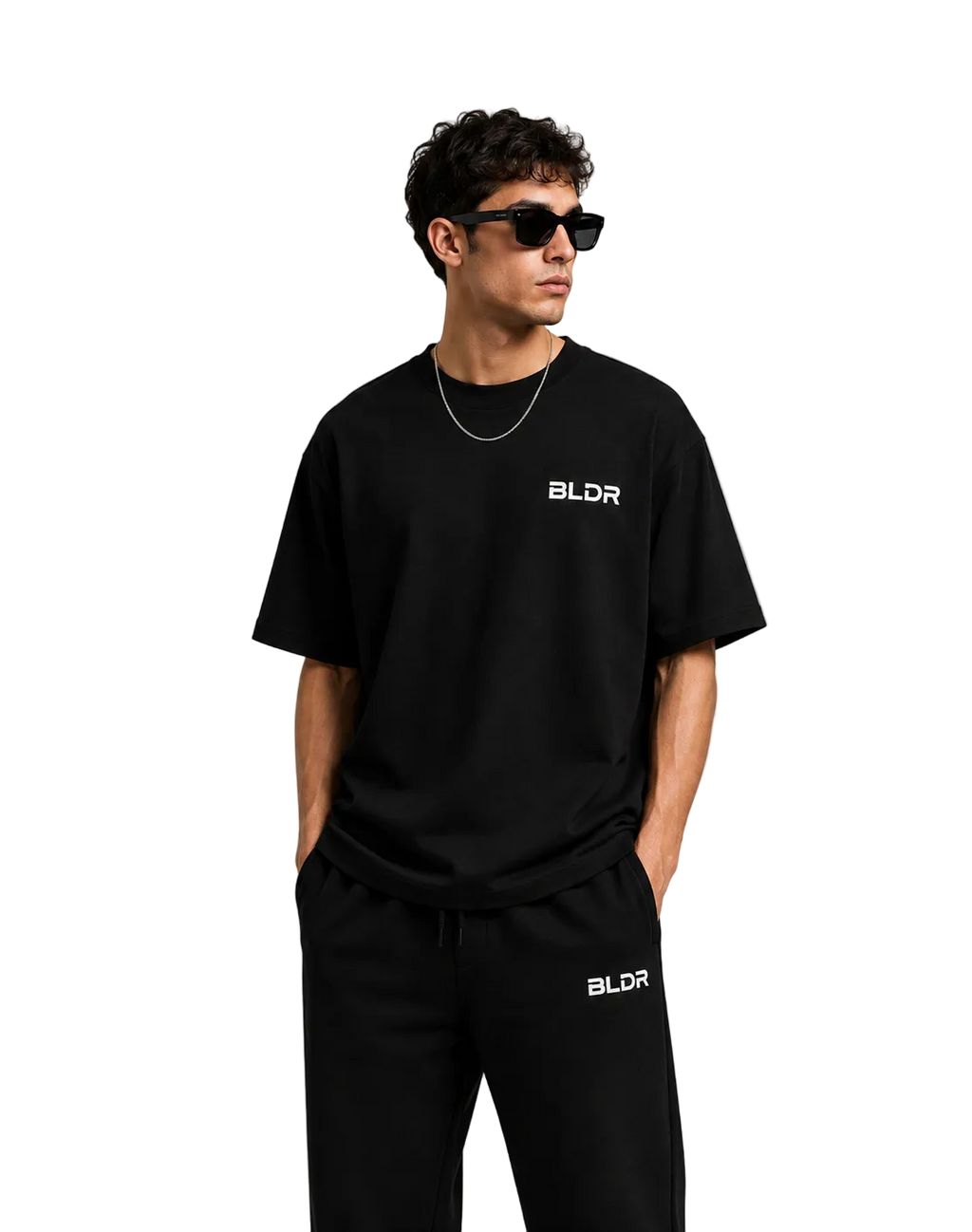 Man wearing a black 'BLDR' t-shirt and pants on a white background