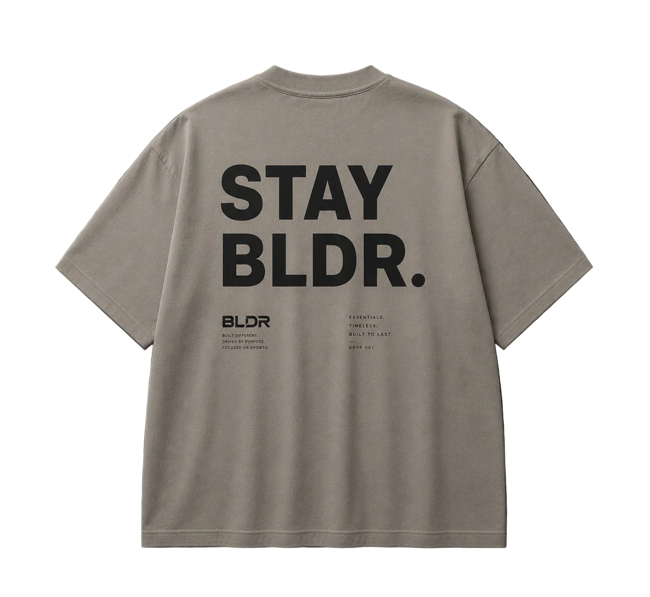 Beige t-shirt with 'STAY BLDR.' text on the back against a gray background