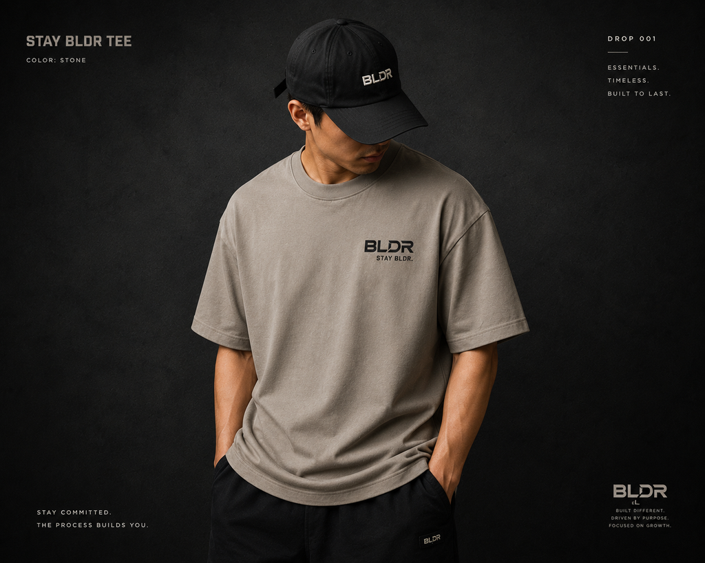 Person wearing a gray t-shirt and black cap with 'BLDR' branding on a dark background