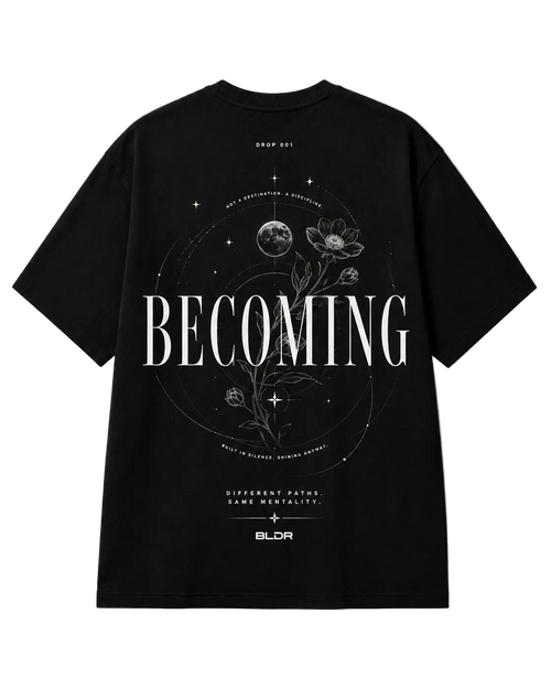 Black t-shirt with 'BECOMING' text and floral design on a white background