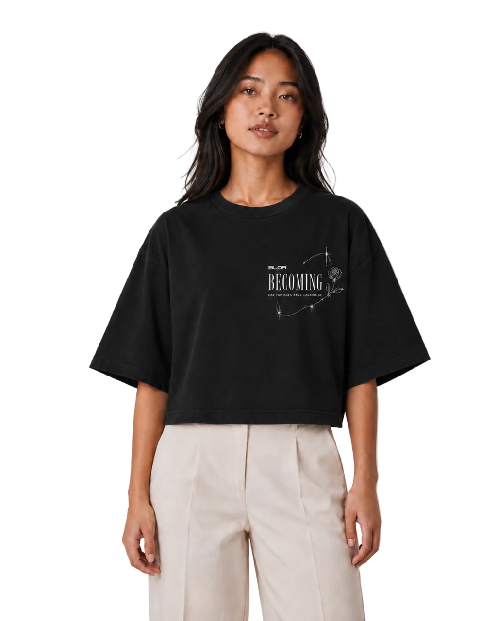 Person wearing a black t-shirt with text and graphics on a plain background