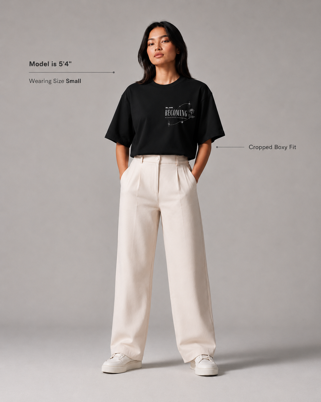 Person wearing a black t-shirt and white pants on a gray background
