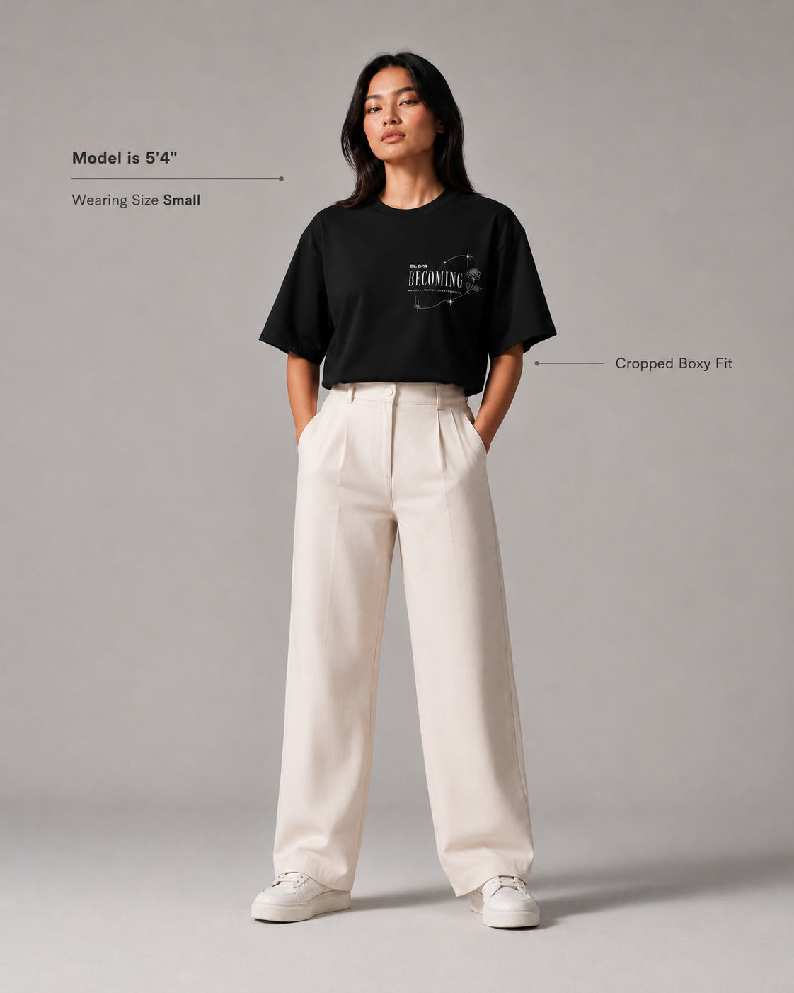 Person wearing a black t-shirt and white pants on a gray background