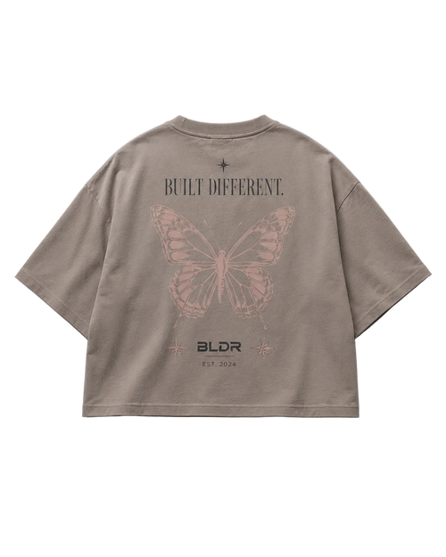 Brown t-shirt with butterfly design and text on a gray background