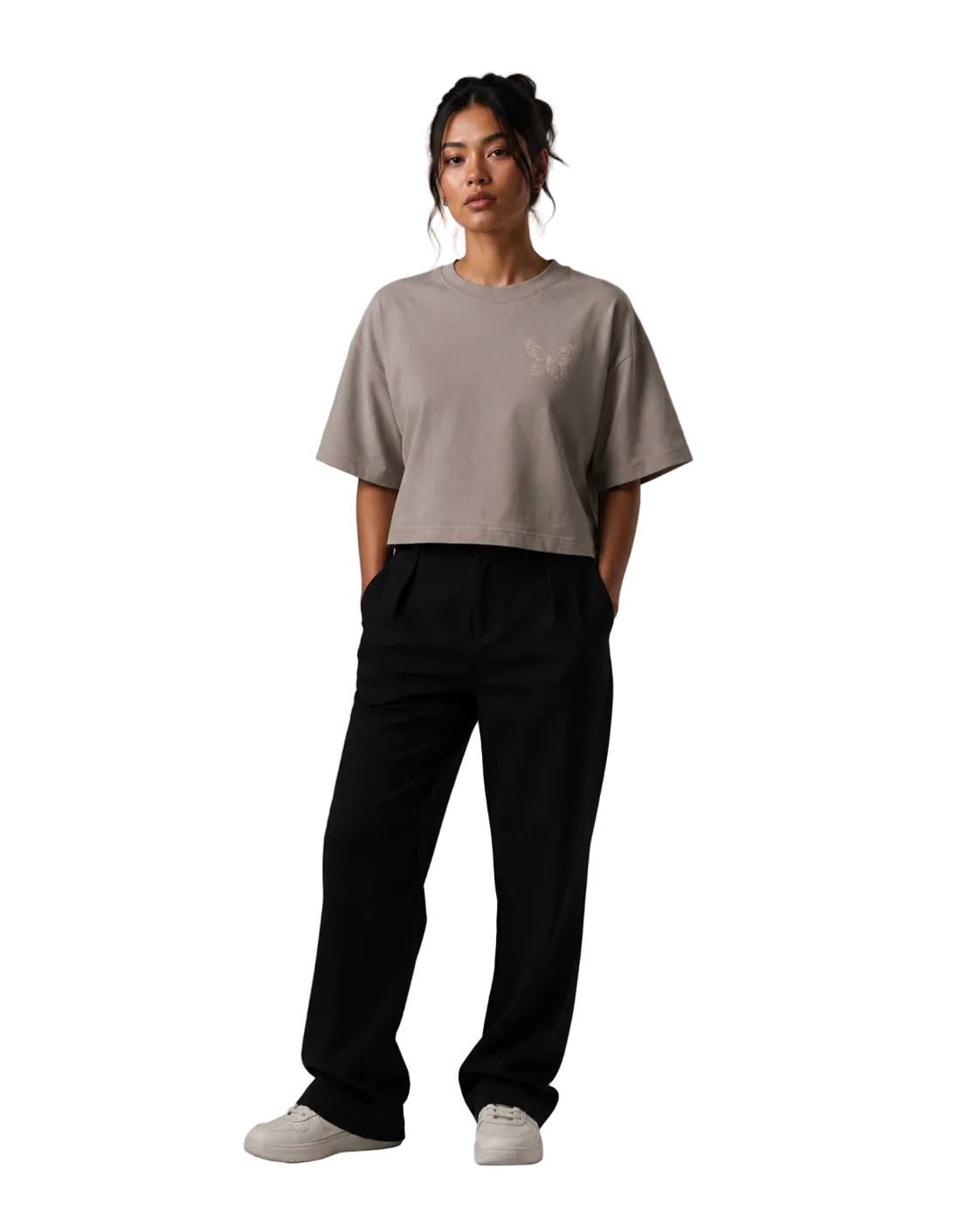 Person wearing a beige t-shirt and black pants on a gray background